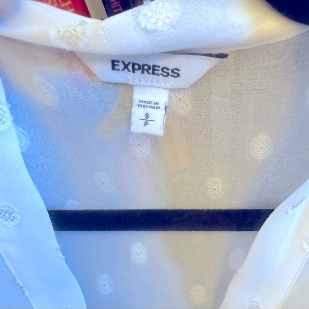 White button-down blouse with polkadots and a tie front